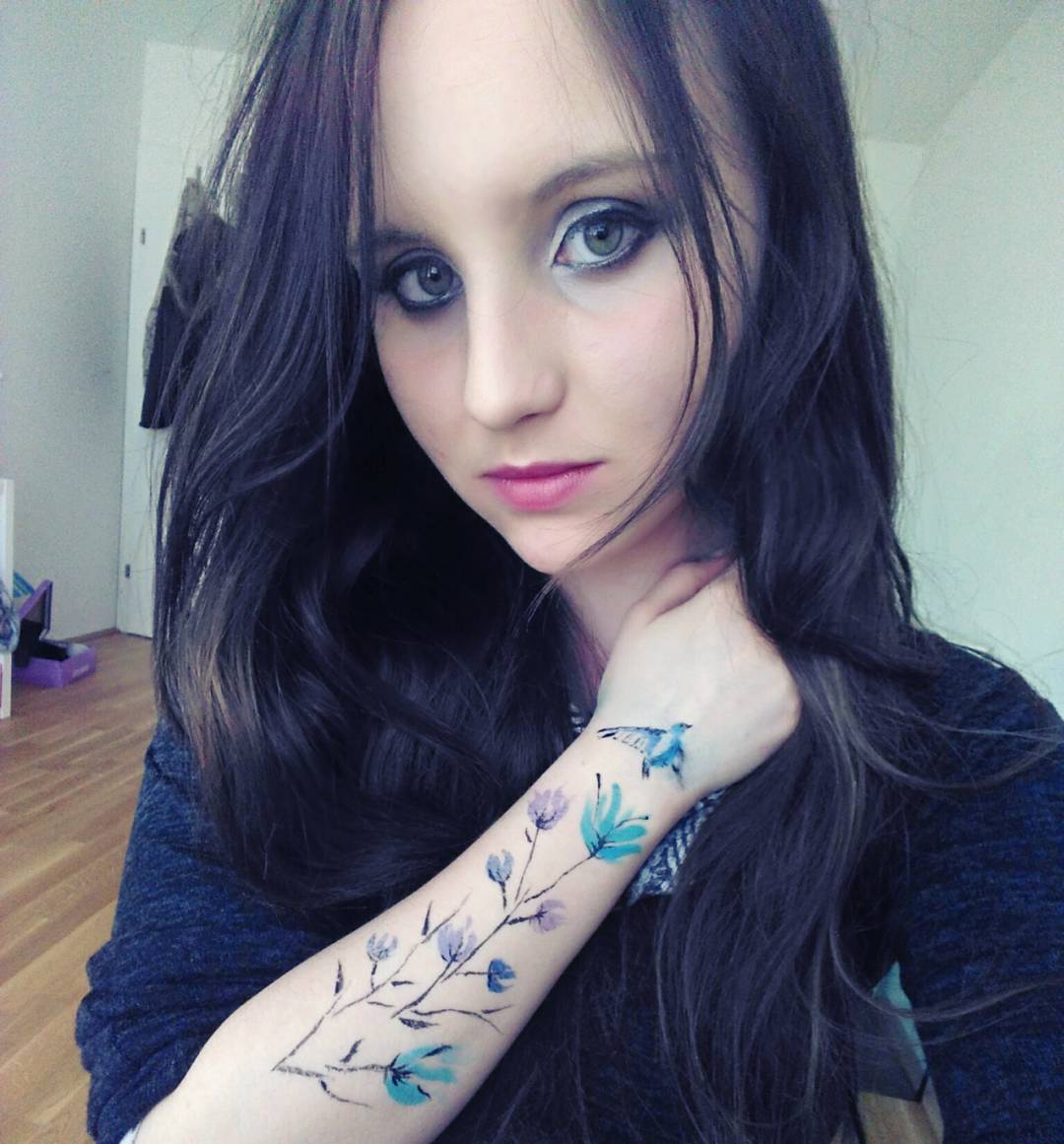 Bird With Flowers On Arm