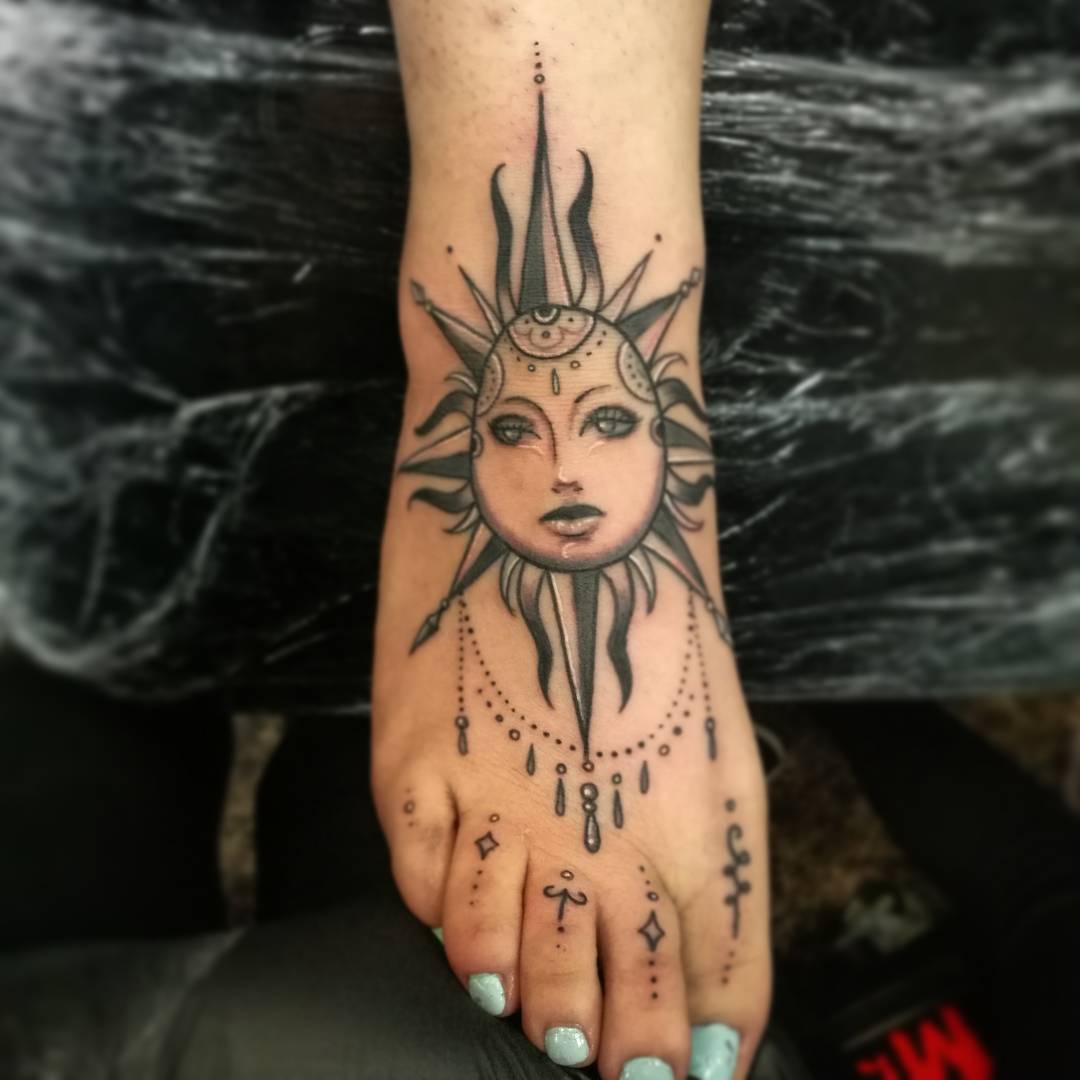 Black And Grey Sun Tattoo On Foot