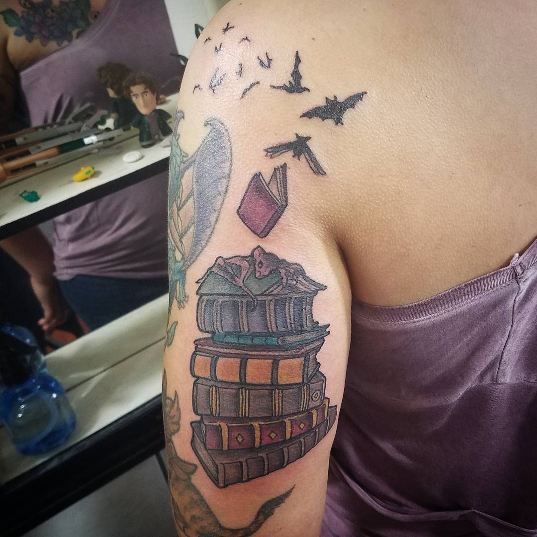 Book With Bats Inked On Shoulder