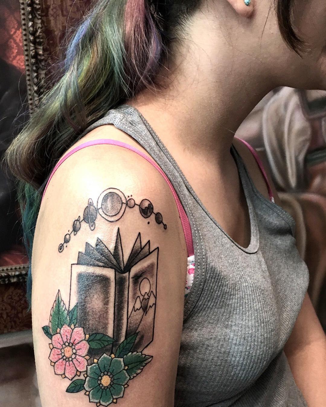 Book With Solar System Inked On Arm