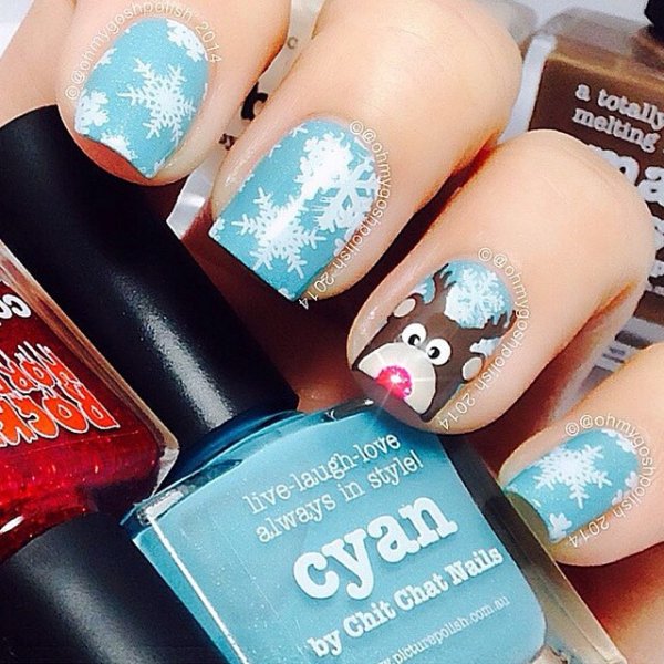Lovely light blue nails with snowflakes and reindeer. Pic by nailartpic_