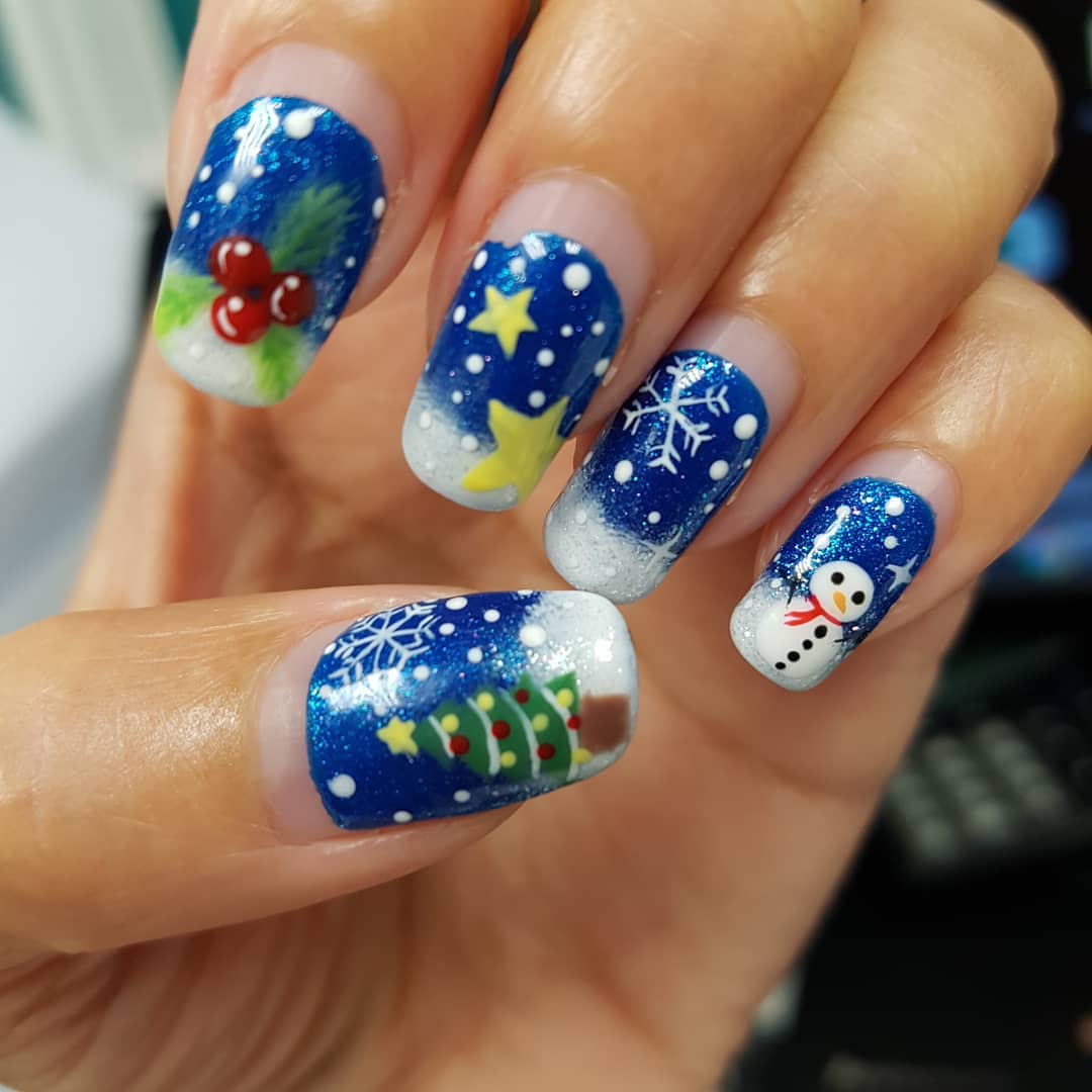 Pretty blue nails with Christmas tree, snowman and snowflakes. Pic by sweetie_yan