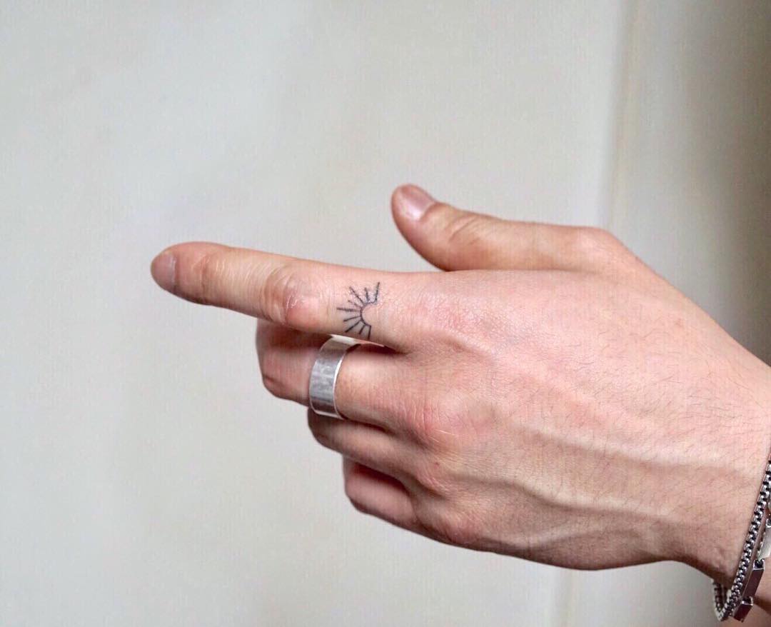 Tiny Sun Tattoo On Finger