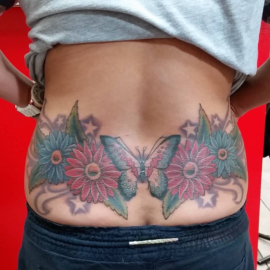 Butterfly With Dasies Lower Back Tattoo