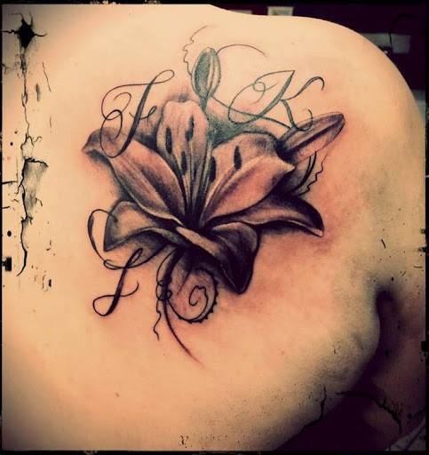 Cool Lily With Words Inked On Upper Back