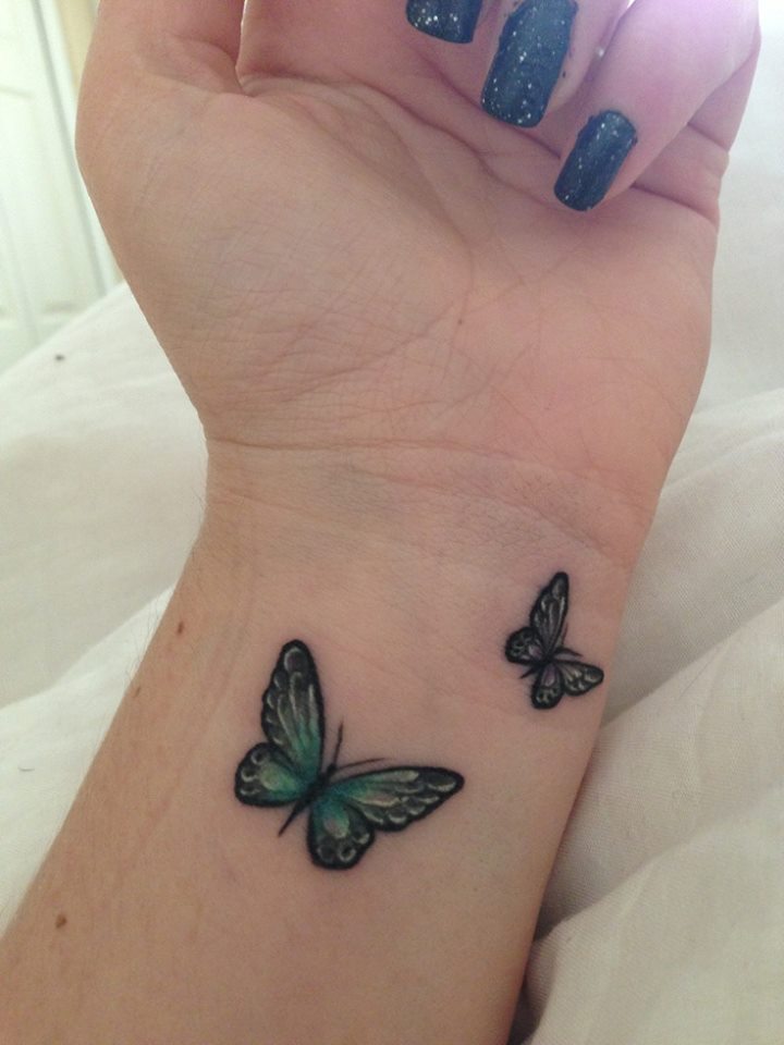 Green Butterflies Flying On Wrist