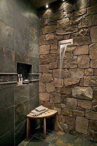 Dashing Shower With Stone Wall And Wooden Stool