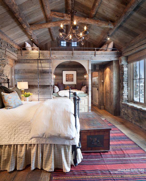 Lovely Spacious Rustic Bedroom With Chandelier, Elegant Carpet And Stone Wall
