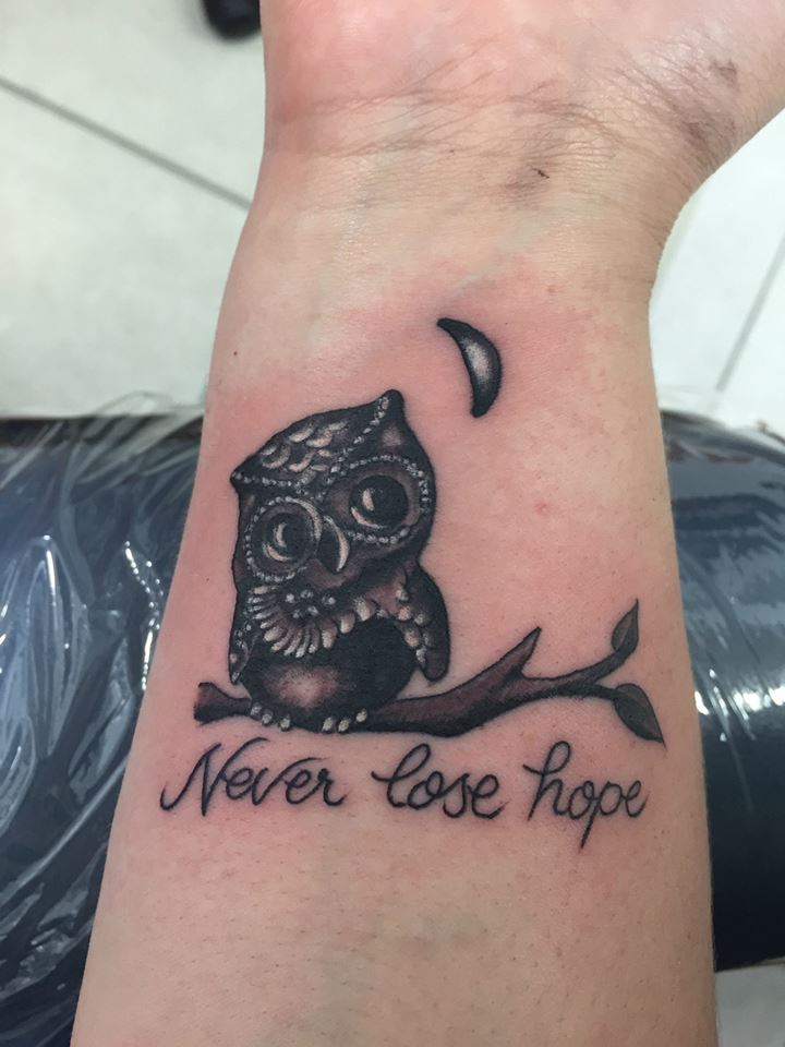 Sassy Little Black Owl Tattoo On Wrist With Quote