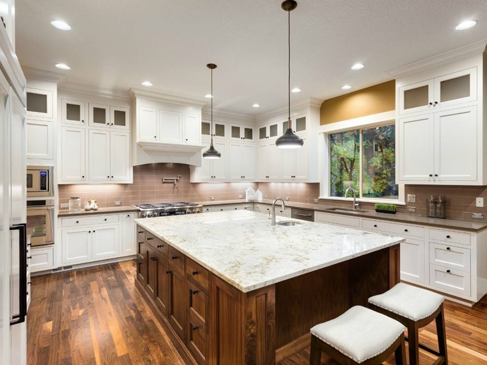 Beautiful White Theme Kitchen With White Marble Kitchen Island And Wooden Flooring