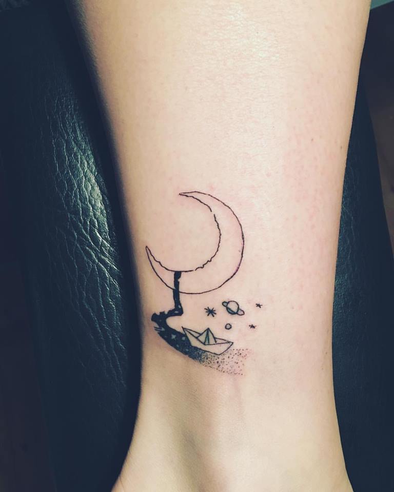 Paper Boat, Sky, Galaxy, Moon, Saturn And Milkyway All Are Inked On Ankle