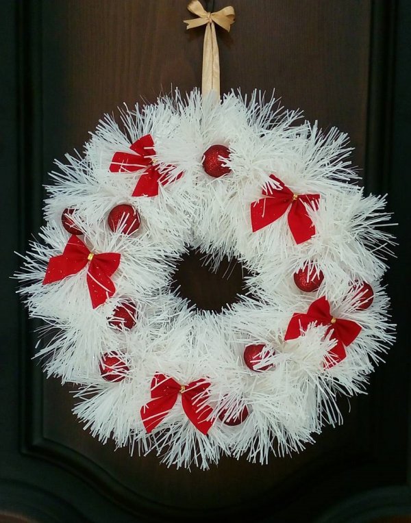 Awesome white Christmas wreath with red balls and bow. Pic by kristinak7