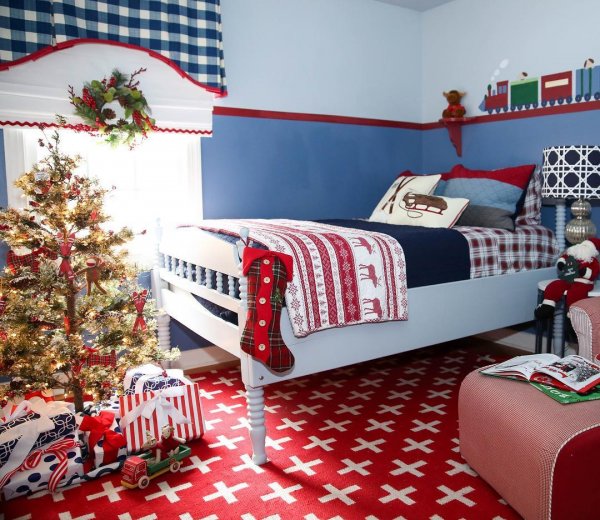 Swiss cross rug, sled pillows, plaid bedsheet, Christmas tree and socks looks amazing. Pic by amyspearinginteriors