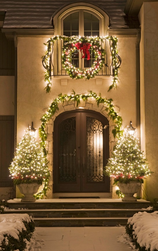 Porch Is Decorated With Trees And Lights