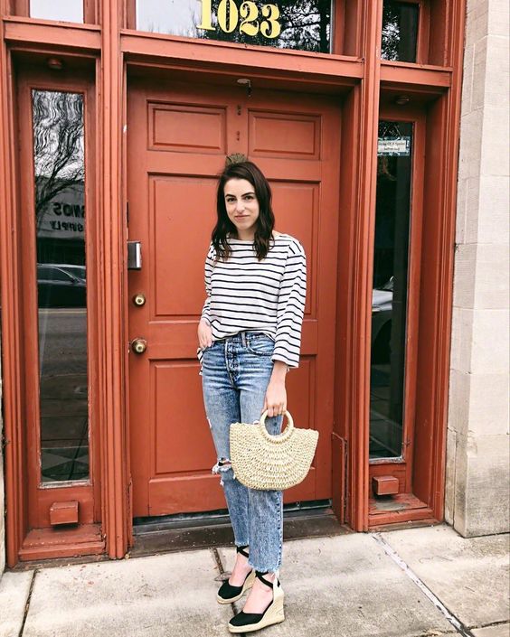 Dashing Stripes Top With Ripped Jeans And Straw Handbag