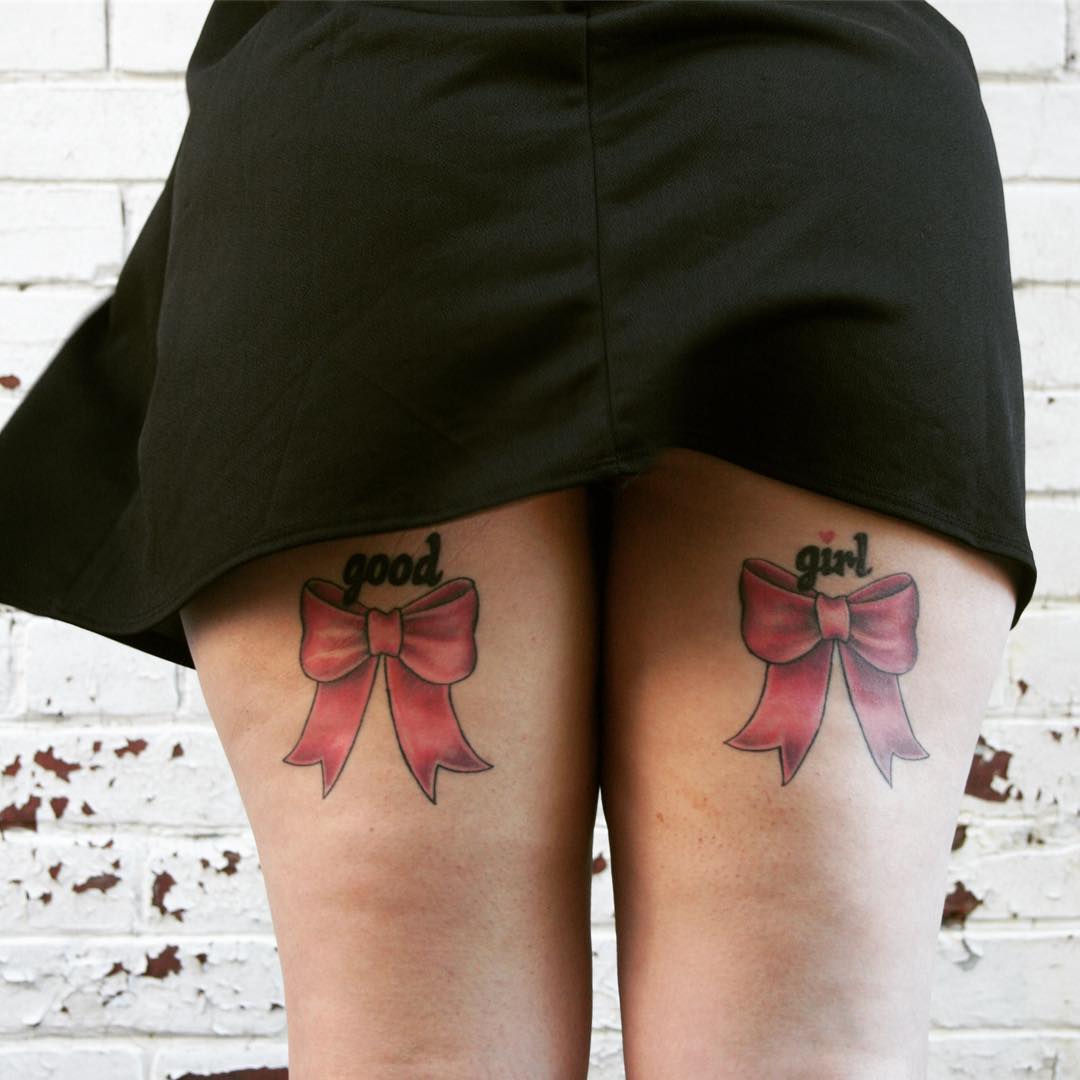 Eye-Catching Feminist Bow Tattoo On Thighs