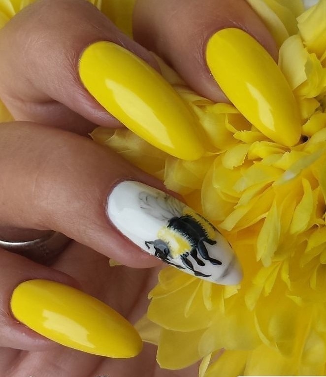 Marvelous Bright Yellow Nails With Bee On Finger Nail