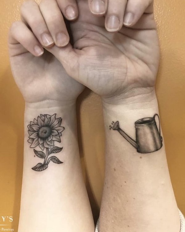 Magical Watering Cane And Flower Tattoo For Mother And Daughter