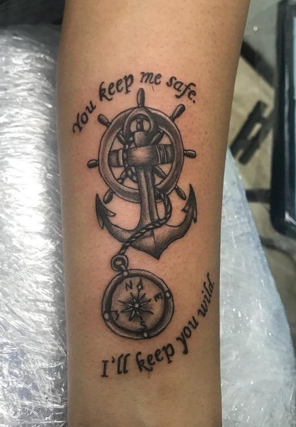 Dashing black and grey anchor tattoo with compass