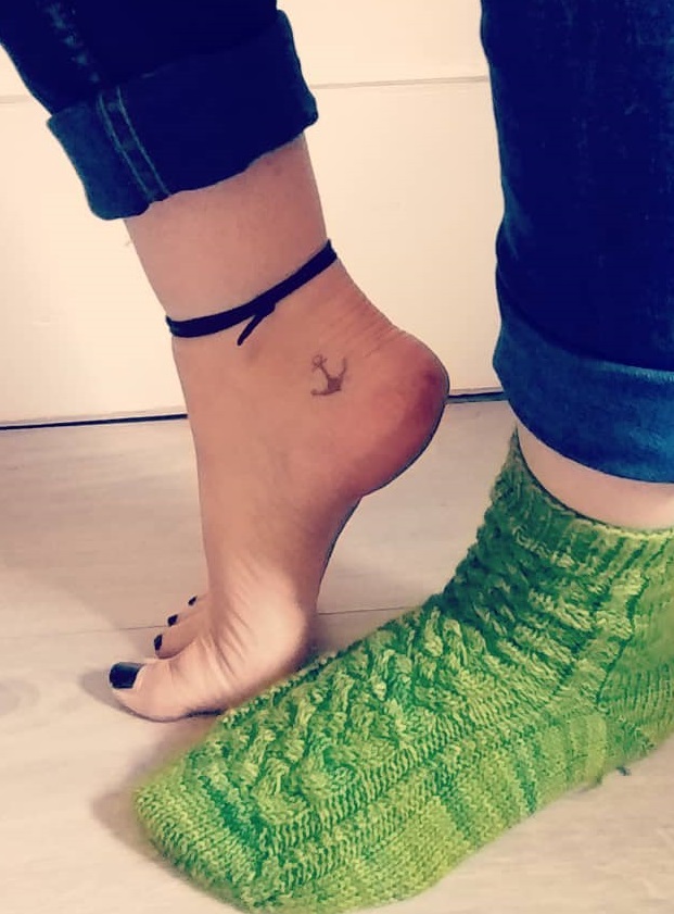 Dazzling small anchor tattoo on ankle