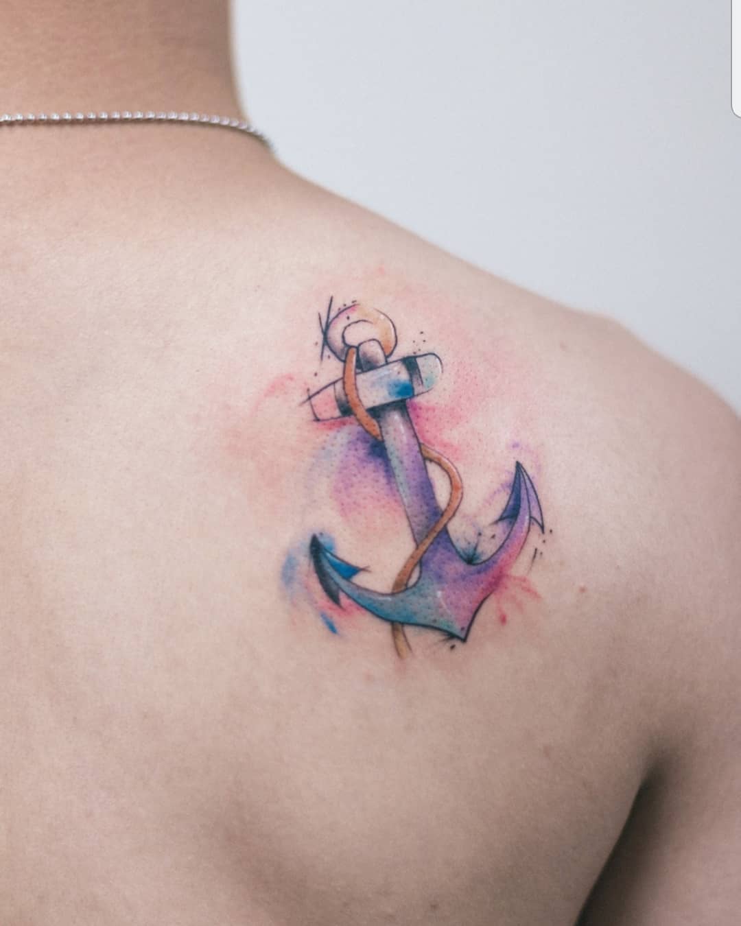 Dreamy watercolor anchor tattoo on shoulder