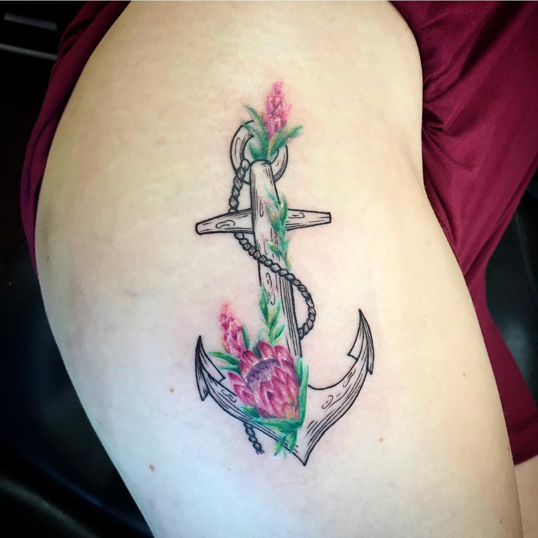 Floral anchor tattoo on hips
