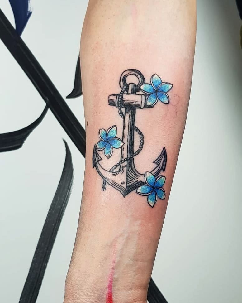Incredible blue flowers with anchor on forearm