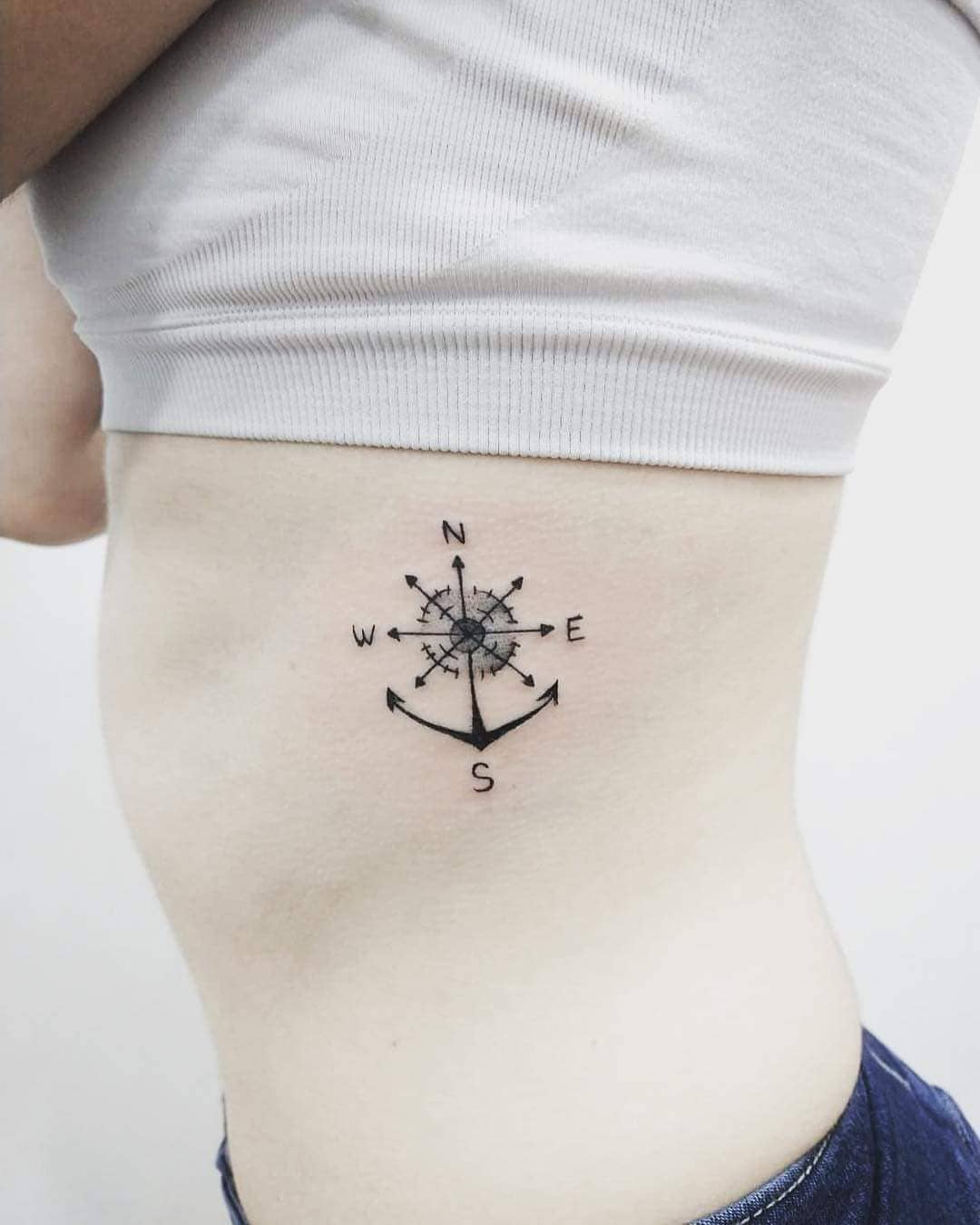 Marvelous ankle tattoo with compass on ribs