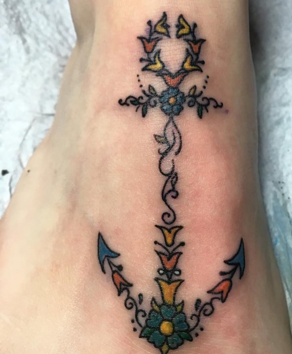 Wonderful anchor tattoo decorated with flowers