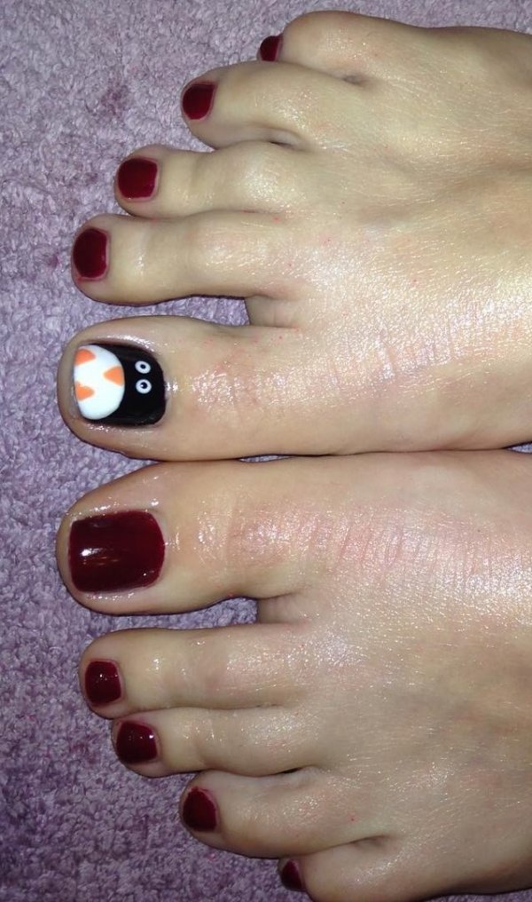 Maroon toes with penguin. Pic by nail_envy_sussex