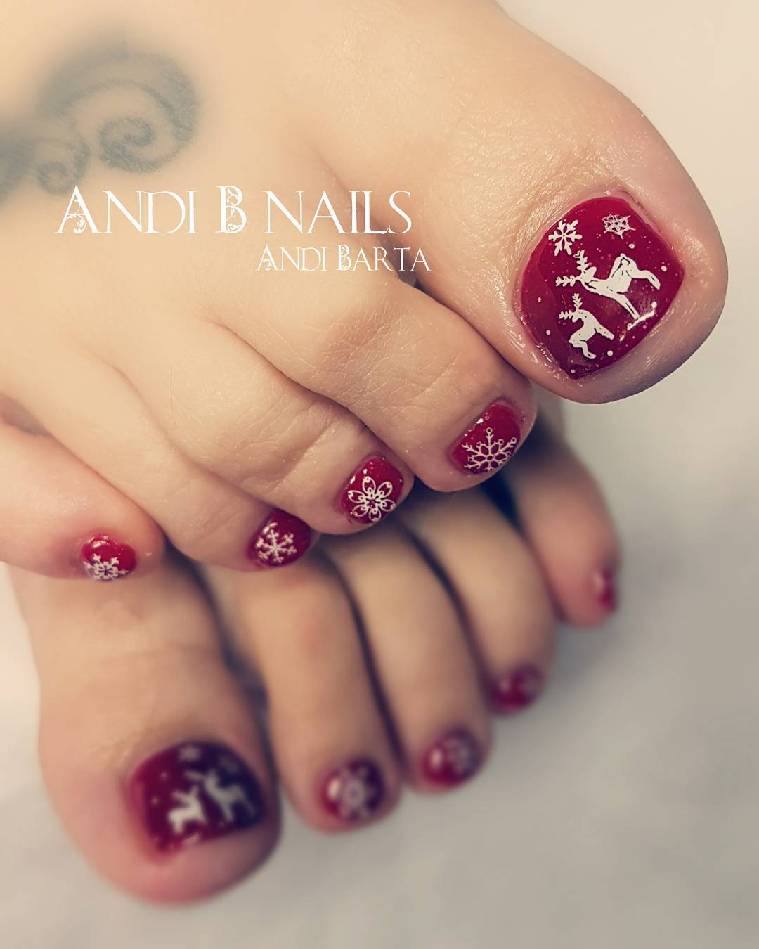 Marvelous red nails with reindeer and snowflakes. Pic by andibnailsandlashes