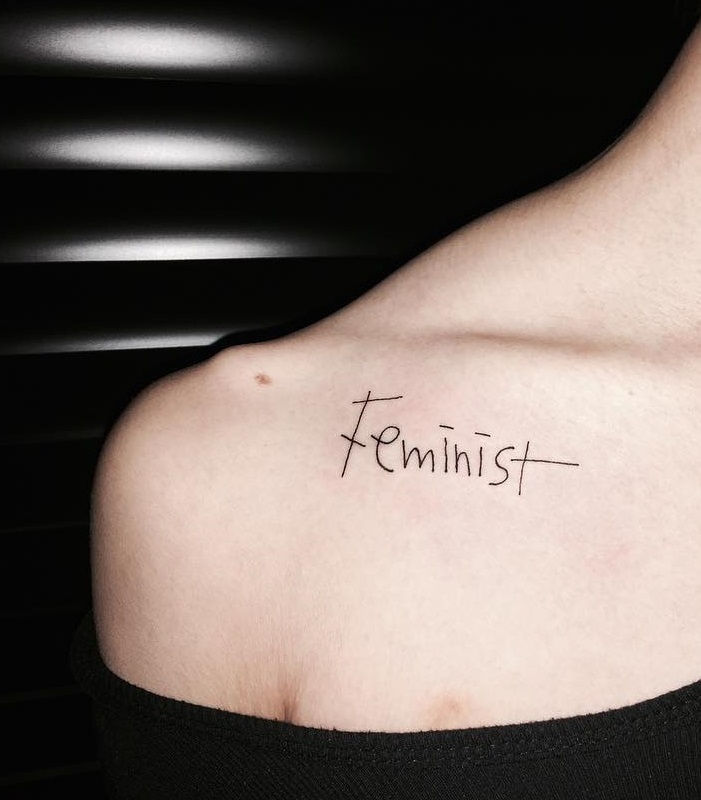 Best feminist fine line tattoo on collar bone. Pic by o_oheun