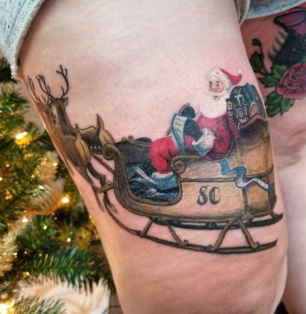 Colorful Santa tattoo on upper leg.