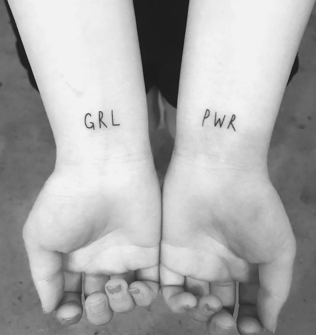Cute girl power lettering tattoo on both wrist. Pic by doodle.popo