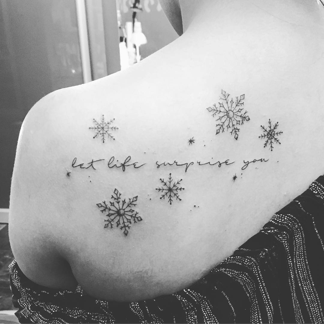 Elegant snowflakes with quote tattoo on shoulder.
