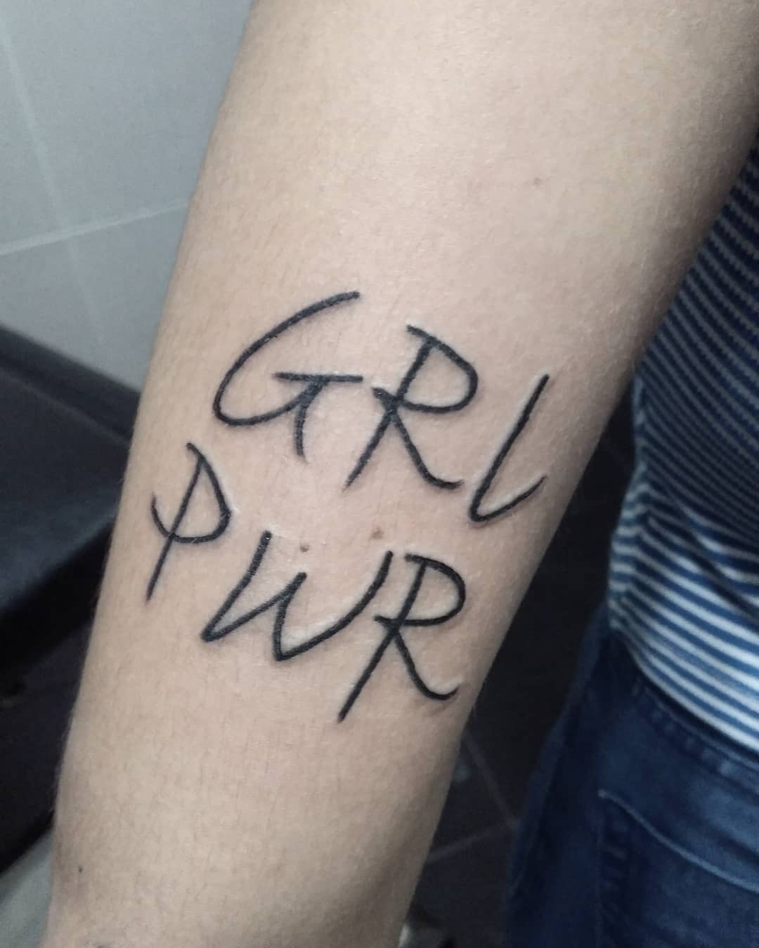 Girl Power lettering feminism tattoo. Pic by andresantxstattoo