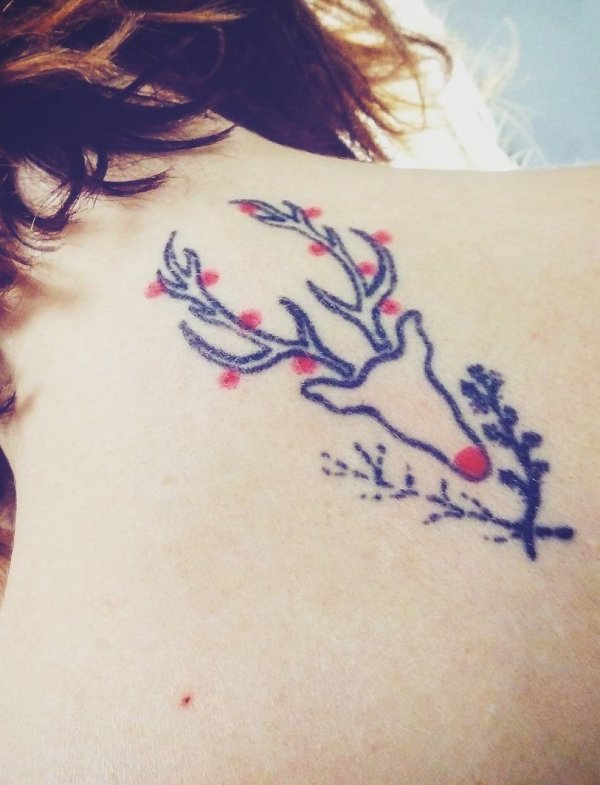 Joyful line work reindeer tattoo on back shoulder.
