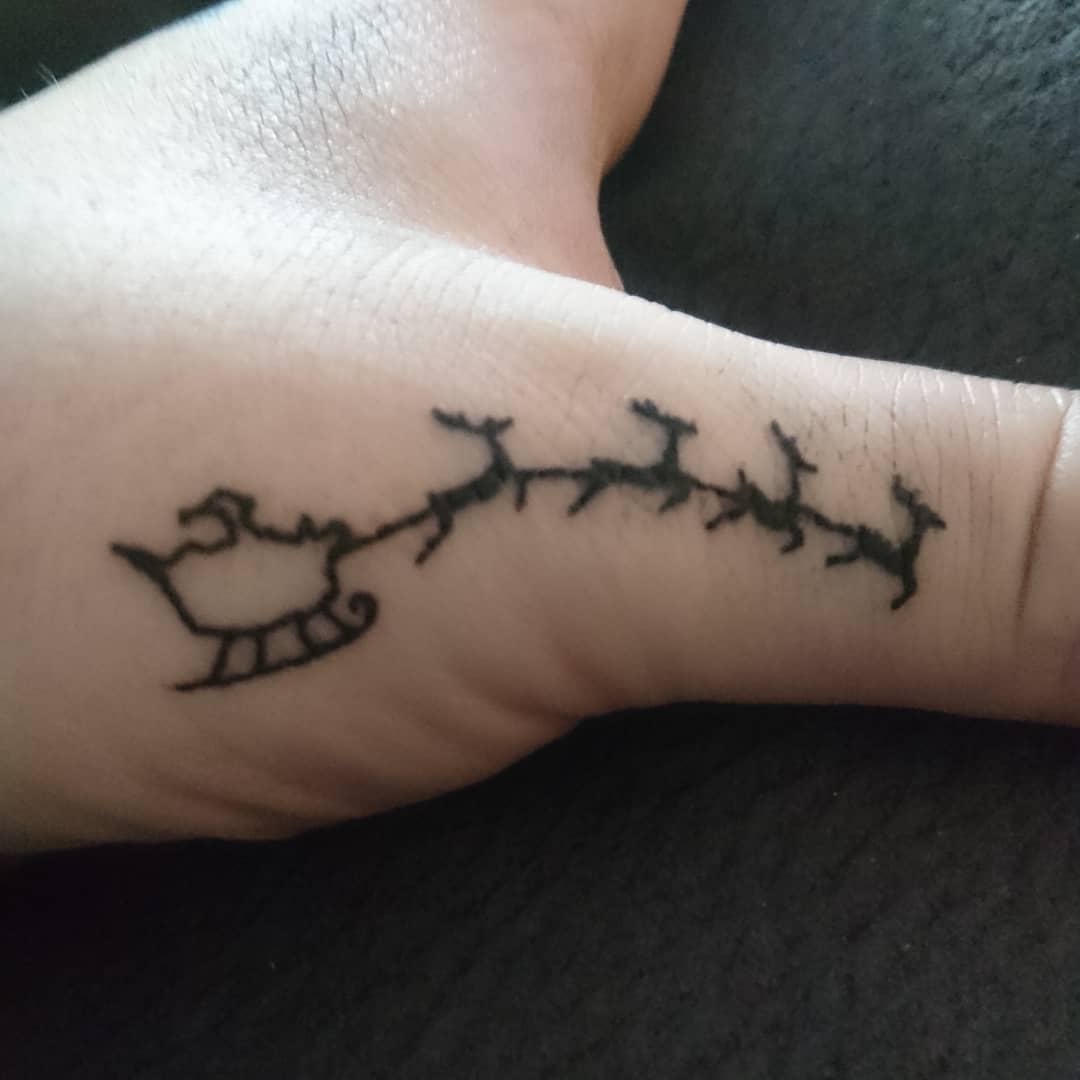 Little Christmas tattoo on thumb
