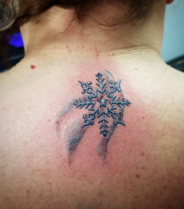 Ravishing snowflake Christmas tattoo on neck.