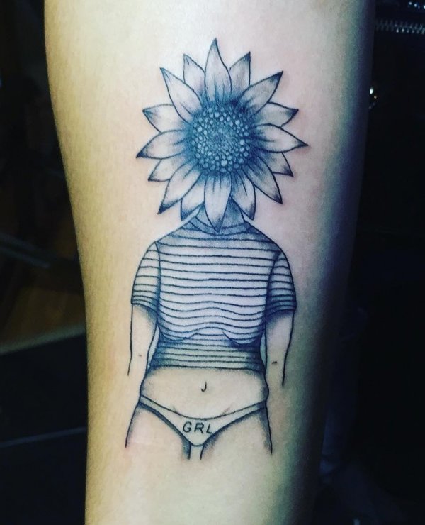 Sunflower girl power tattoo on leg. Pic by wendelldiegotattoo