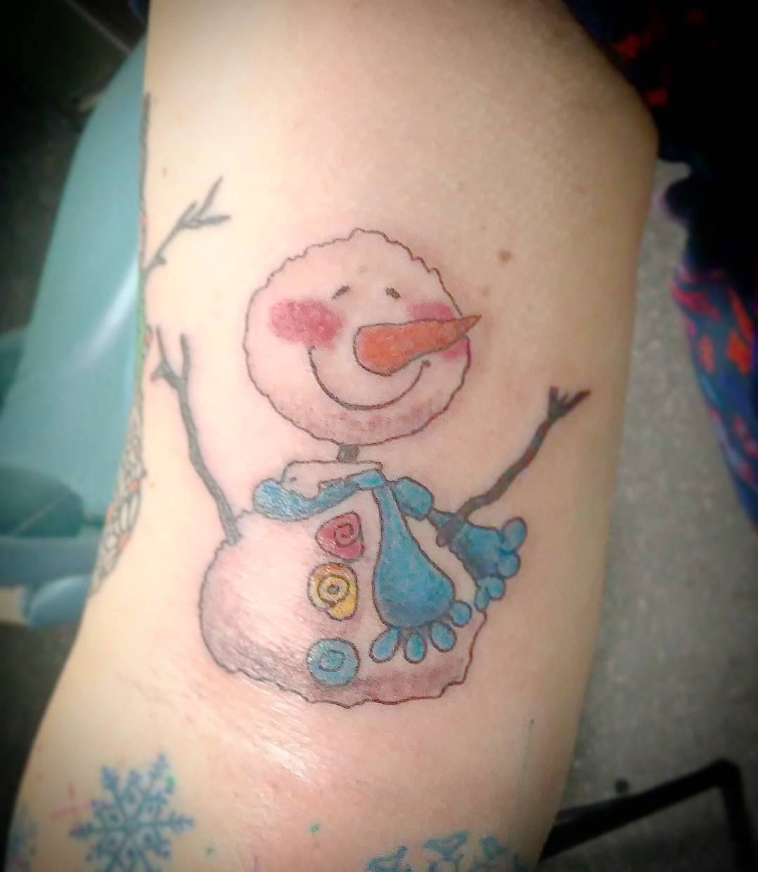 Sweet snowman half sleeve tattoo.