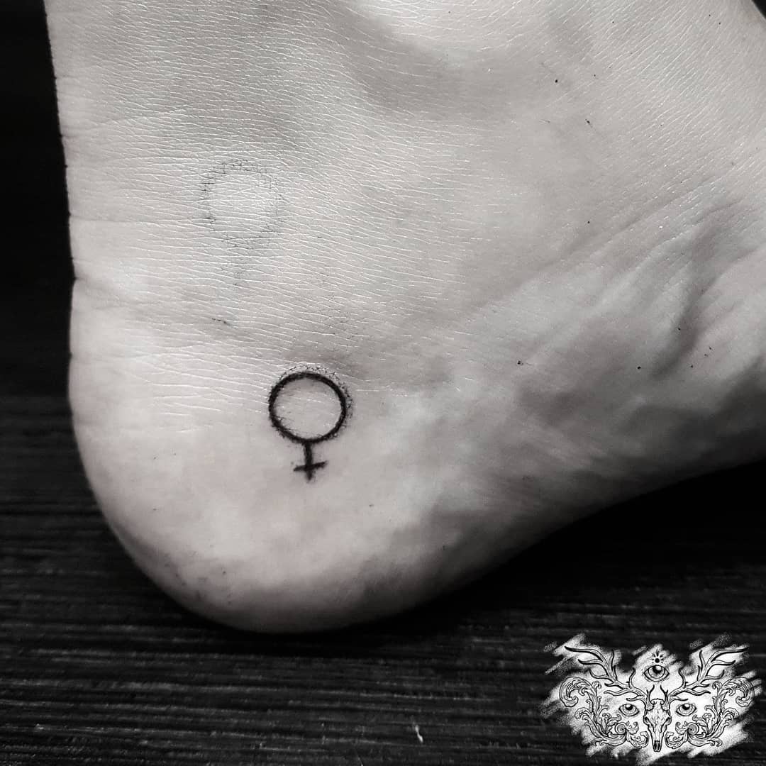 Tiny girl power tattoo on ankle. Pic by wendigoink