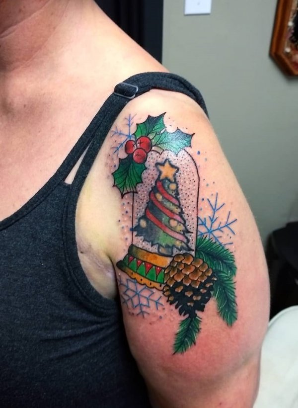 Traditional Christmas tree with snowflake on shoulder