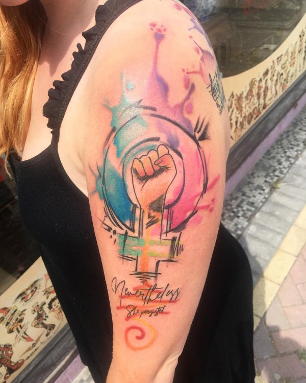 Water color feminist tattoo on half sleeve. Pic by gemmadenisetattoo