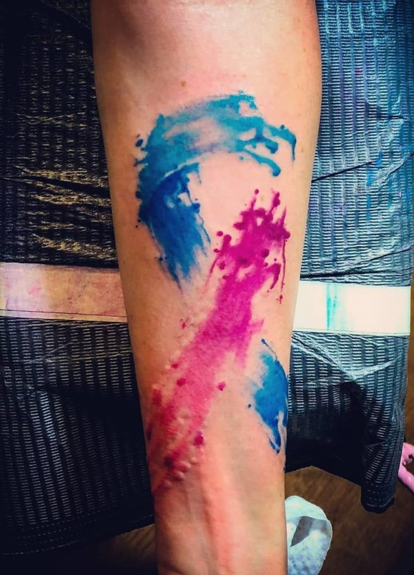 A cancer survivor tattoo done in a watercolor style on half sleeve.