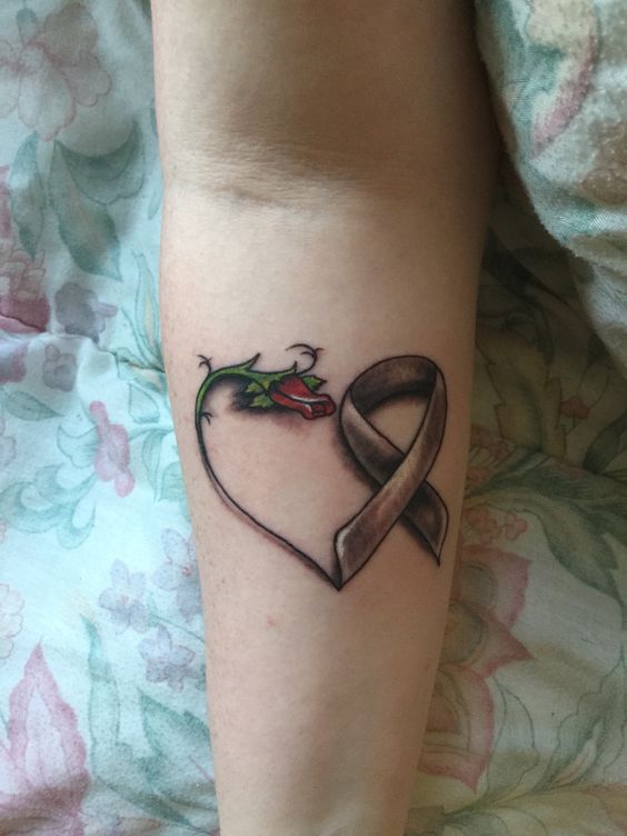 A rose and a cancer ribbon shaped into a heart.