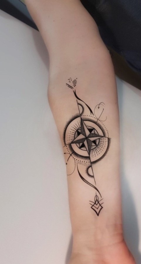Artistic compass tattoo on arm looks beautiful.