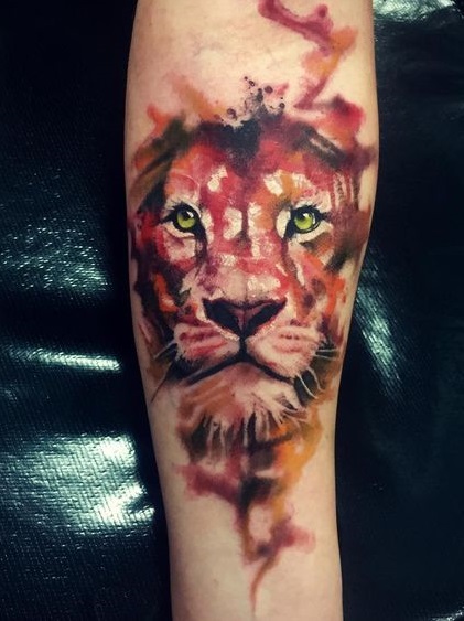 Awesome lion tattoo on arm in watercolor.