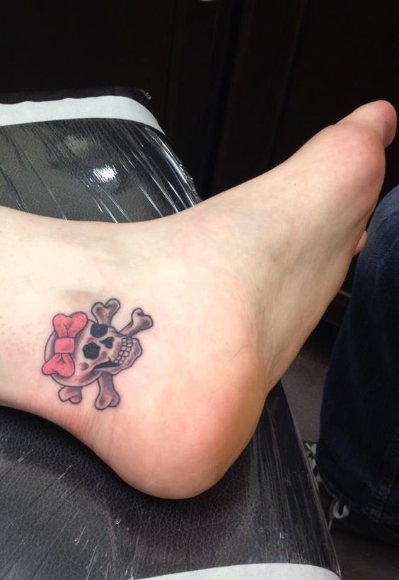 Awesome skull and cross bones with bow on ankle.