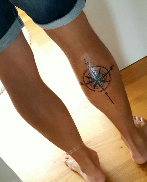 Back leg compass tattoo looks simple.